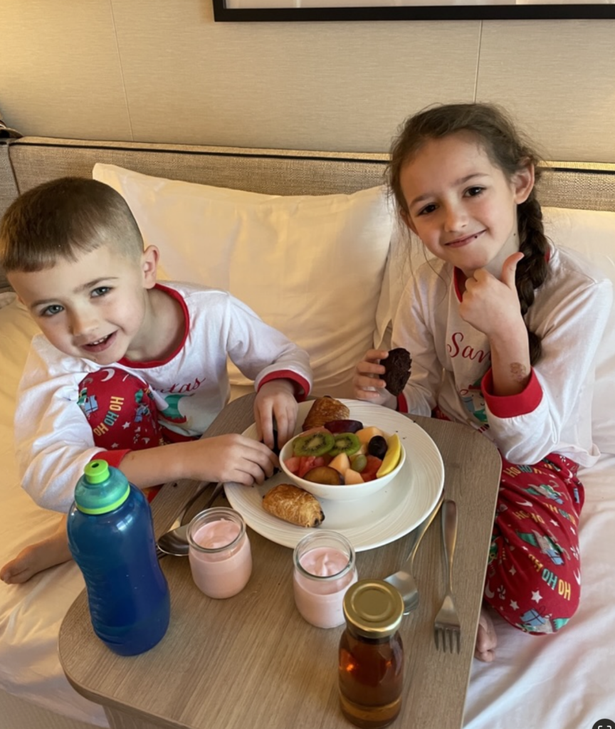 My kids enjoying room service breakfast on Christmas day on Arvia